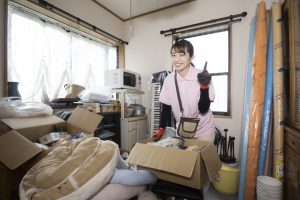 ゴミ屋敷を清掃する女性スタッフ